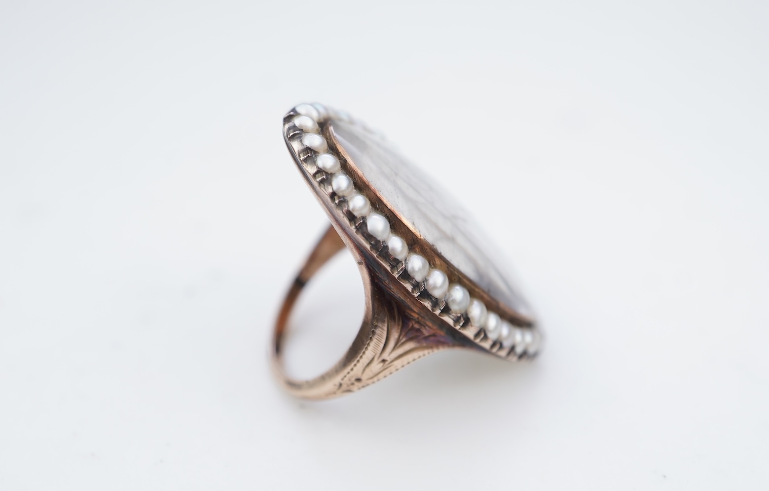 A fine George III seed pearl, enamel and diamond mourning ring, circa 1782